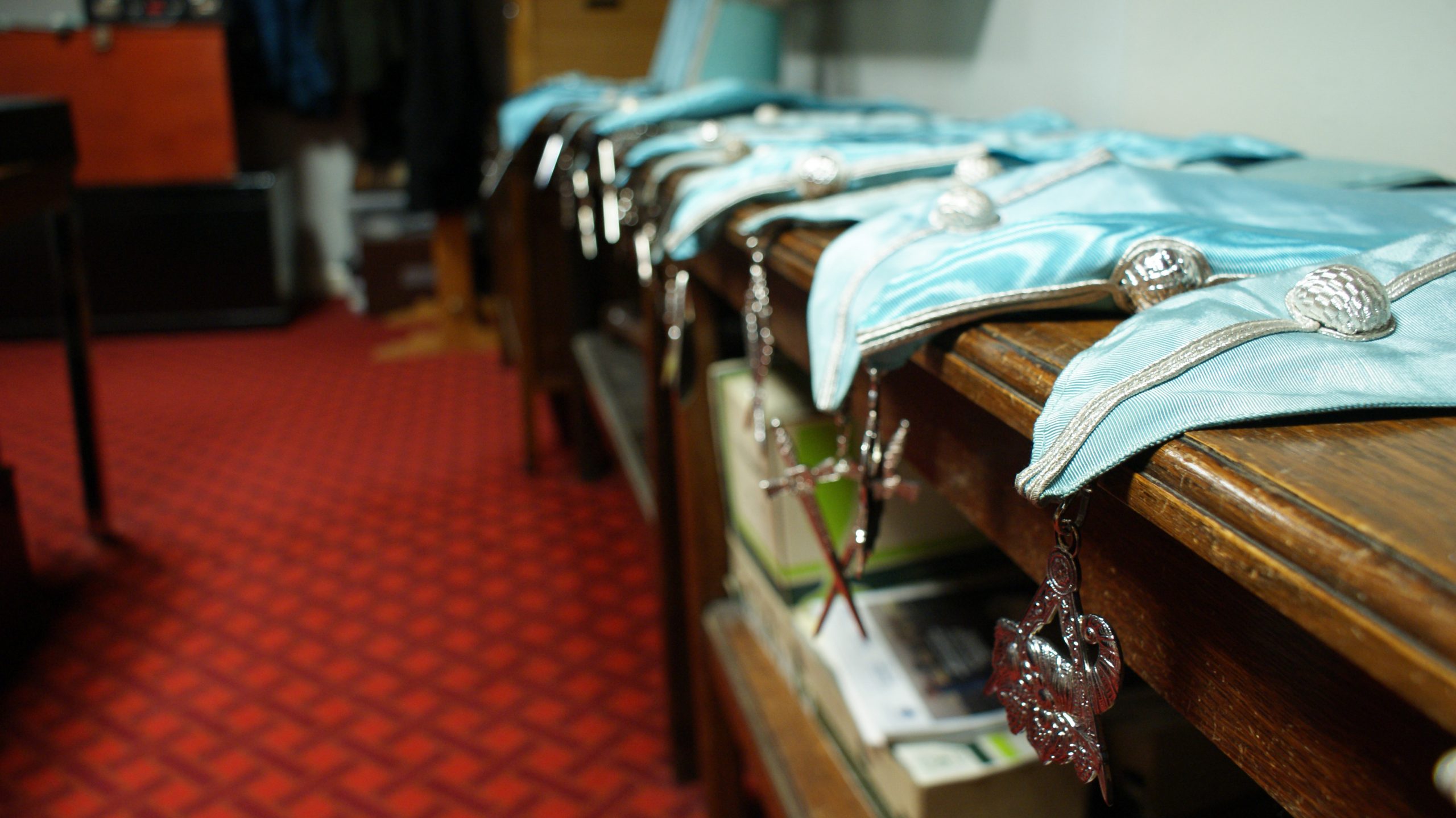 An image of Masonic collars laid out before a meeting.